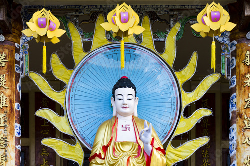 Standing Amitabha Buddha statue on the entrance to Quang Minh Mahayana Buddhism temple in Da Nang, Vietnam  photo