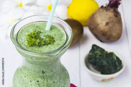 Healthy green smoothie with spinach,kiwi and lemon.