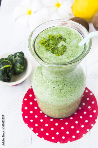 Healthy green smoothie with spinach kiwi and lemon.