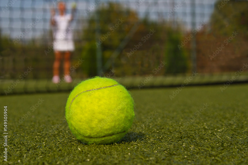 Tennis ball and silhouette of tennis player