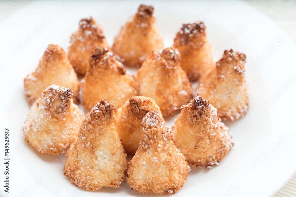 Coconut macaroon cookies on white plate Coconut macaroon cookies on white plate