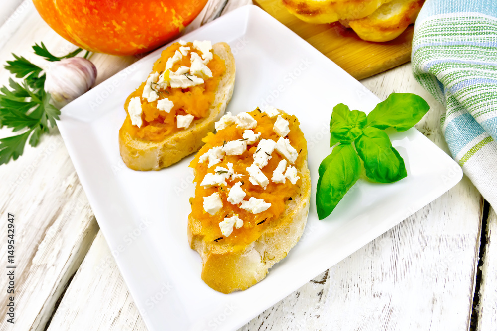 Bruschetta with pumpkin and cheese in plate on board Bruschetta with pumpkin and cheese in plate on board