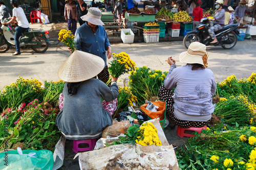 Flower vendors at the Hoi An market in Hoi An Ancient Town, Quang Nam, Vietnam. Hoi An is recognized as a World Heritage Site by UNESCO.