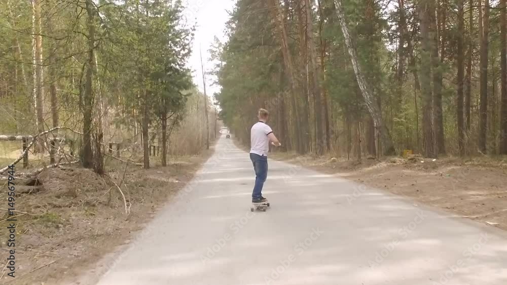guy skate on logboard in a forest with a color smoke grenade , slow motion guy skate on logboard in a forest with a color smoke grenade , slow motion