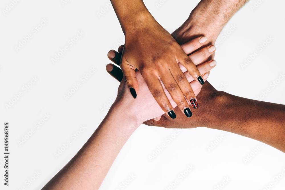 Black and white hands put together on white background . International