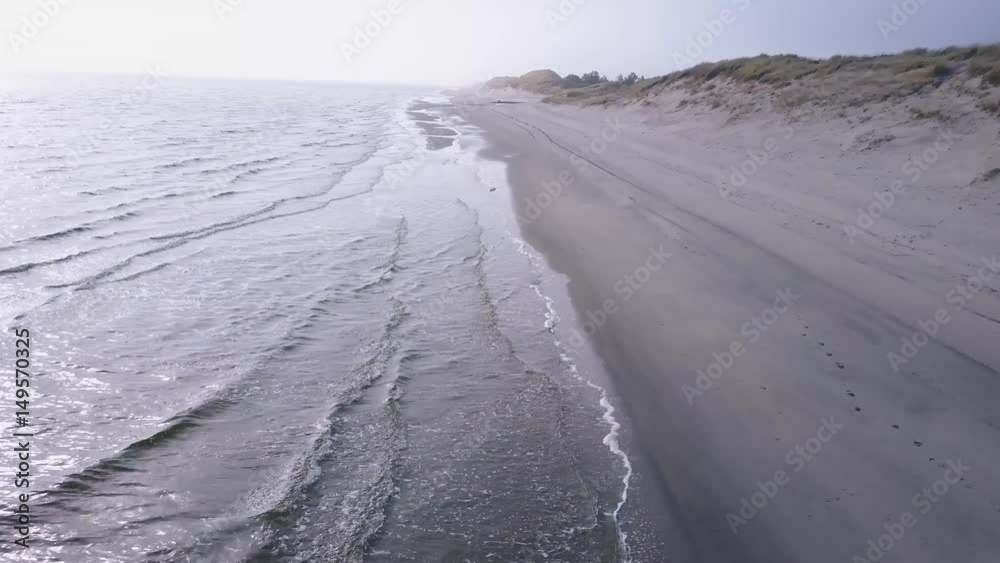 Drone areal shot of the western coastline of denmark spring on the edge of summer with bright sunshine Drone areal shot of the western coastline of denmark spring on the edge of summer with bright sunshine