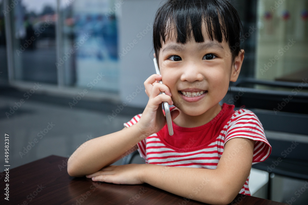 Asian Chinese little girl playing smartphone Asian Chinese little girl playing smartphone