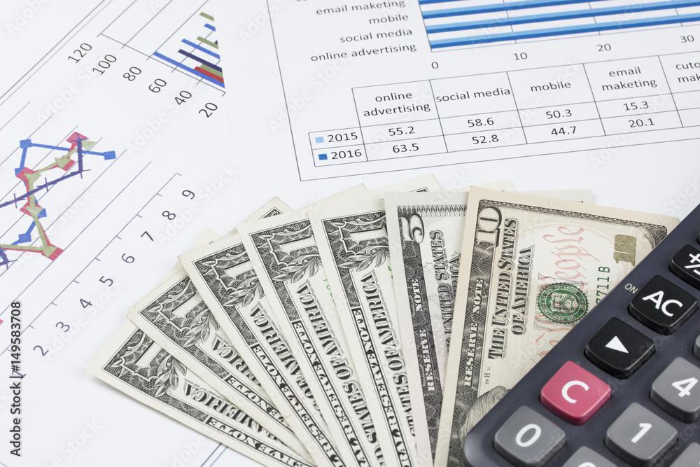 business concept : graph with calculator and money on stock market report as background business concept : graph with calculator and money on stock market report as background