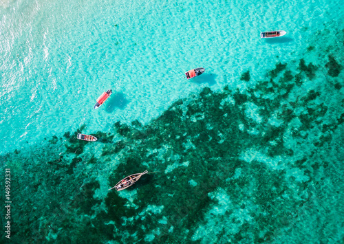 beautiful top view of clear turquoise ocean with many boats