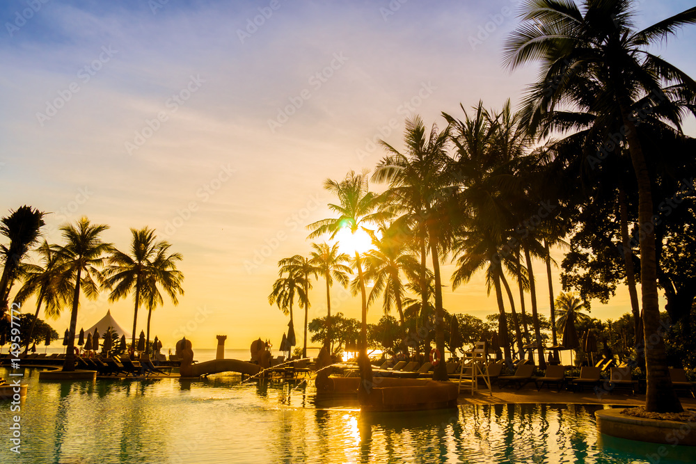 Silhouette coconut palm tree around swimming pool