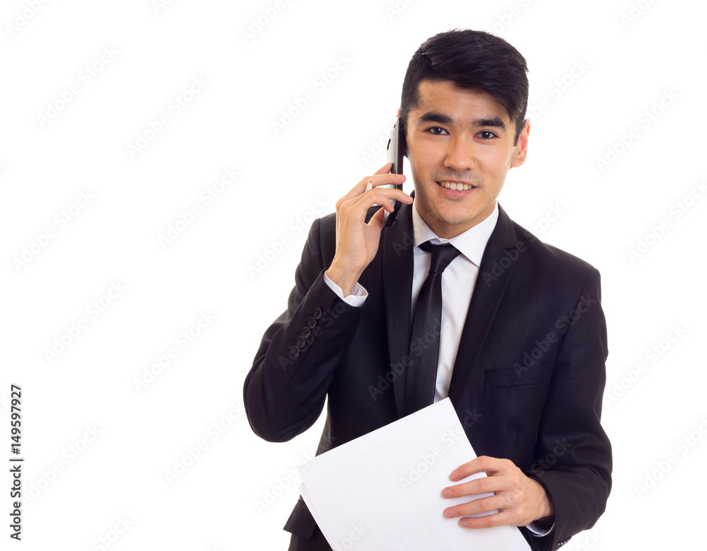 Young man in suit holding papers Young man in suit holding papers