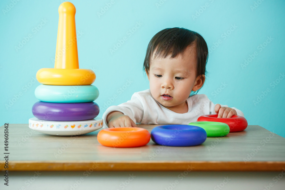 kid toddler playing wooden toys at home or nursery