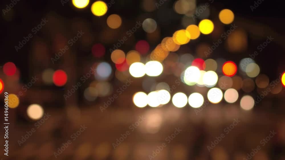 DEFOCUSED BOKEH: Traffic jam on busy road in crowded New York City street during the night. Colorful blurred car headlights and flashing traffic lights glowing in the dark creating magical atmosphere