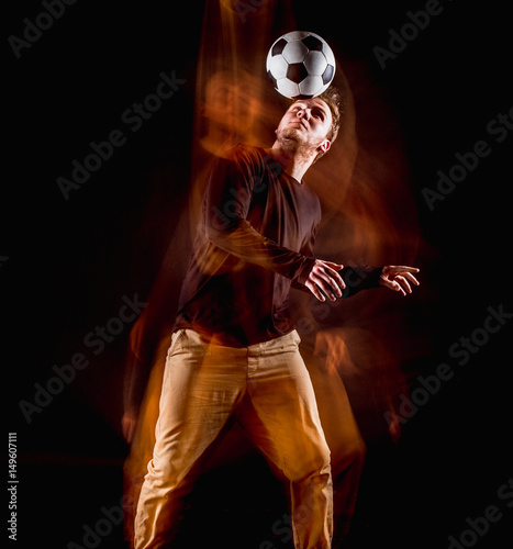 A portrait of a fan with ball on gray studio background. Freestile