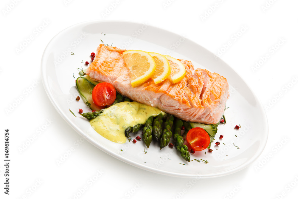 Grilled salmon with french fries on cutting board Grilled salmon with french fries on cutting board