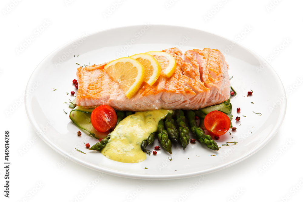 Grilled salmon with french fries on cutting board Grilled salmon with french fries on cutting board