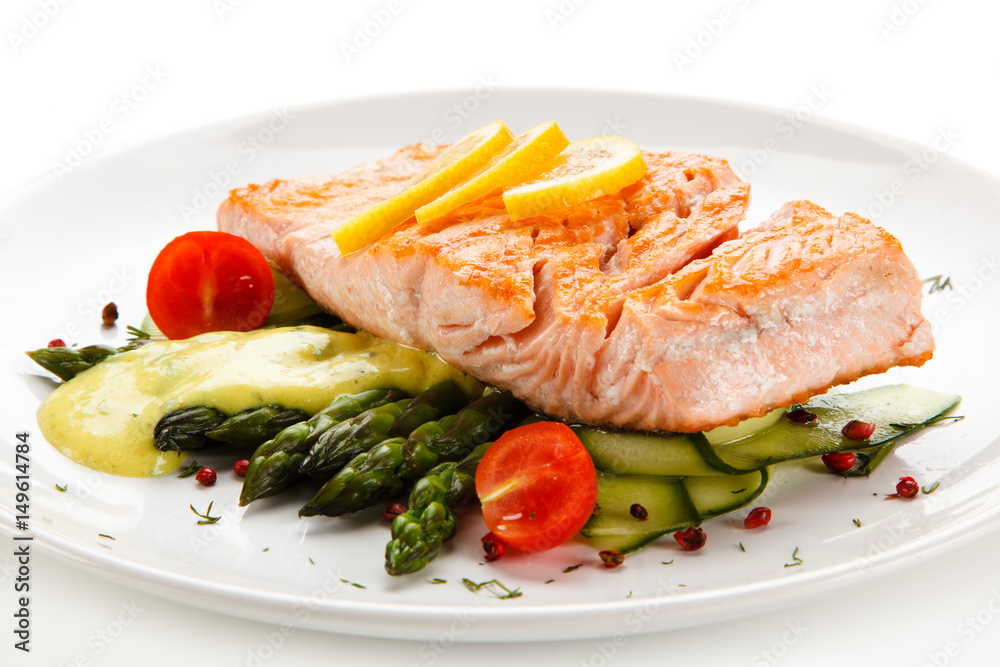 Grilled salmon with french fries on cutting board