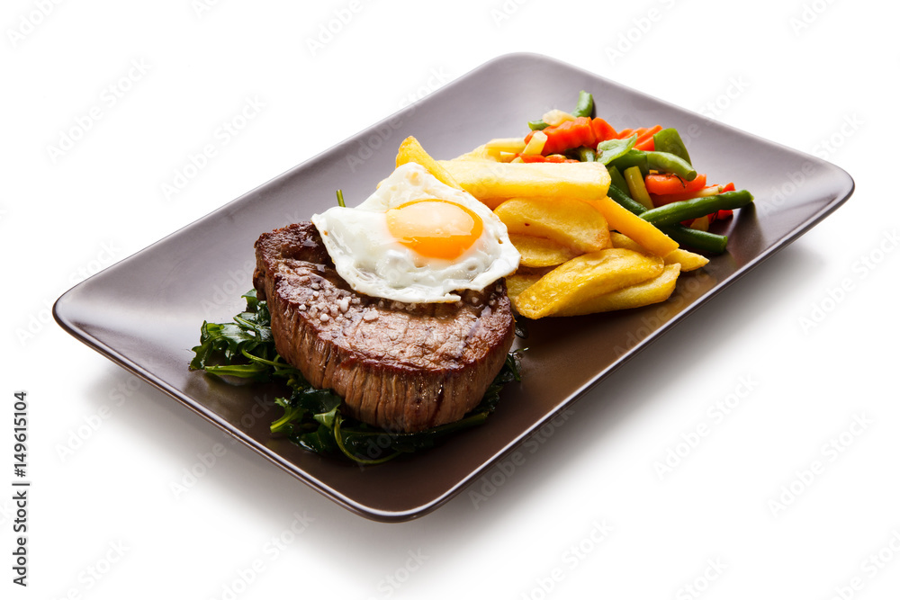 Grilled beefsteak with french fries and egg
