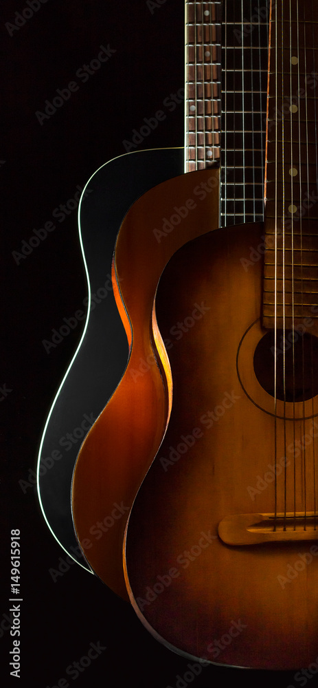 Fototapeta premium Three acoustic guitars on black background