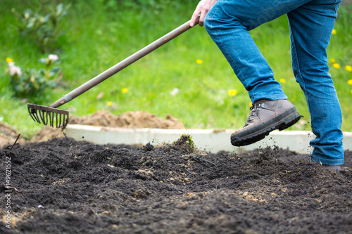 Man working in garden with rake