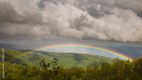 Stormy and ominous skies give way to a vibrant, beautiful rainbow over the Shenandoah Valley