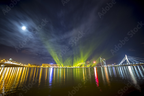 Light beams over river Daugava in Riga Latvia