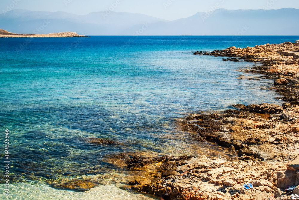 Blue sea and sharp rocks that surround it