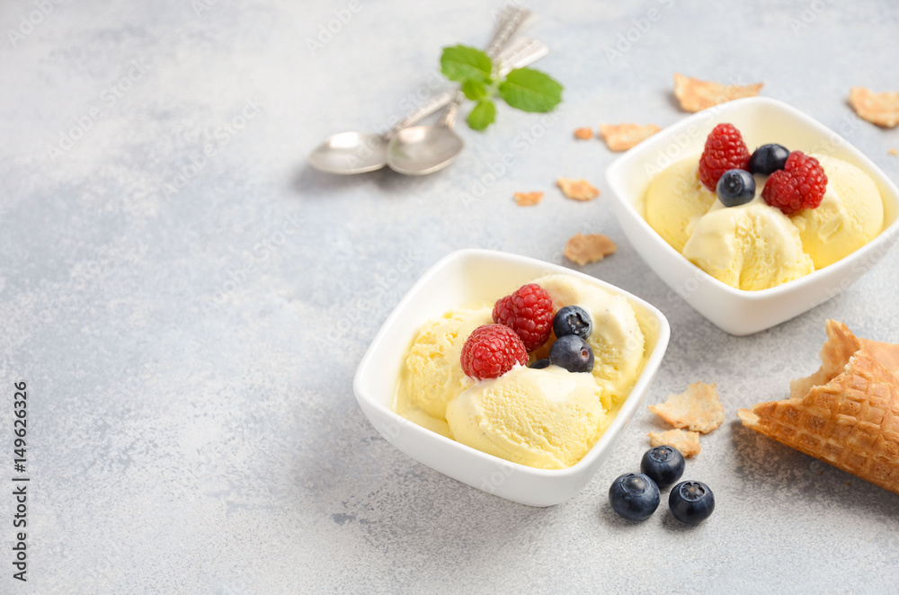 Vanilla ice cream with fresh berries on concrete background, selective focus, copy space Vanilla ice cream with fresh berries on concrete background, selective focus, copy space