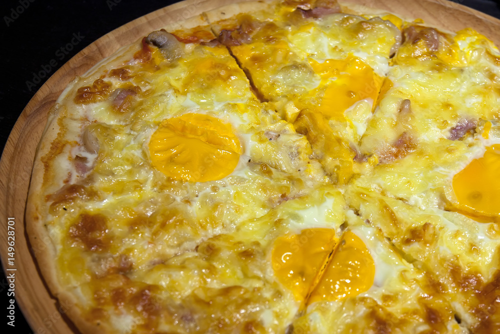egg with mushroom and ham pizza on the wood tray and black counter bar for dinner food in the restaurant on nature light egg with mushroom and ham pizza on the wood tray and black counter bar for dinner food in the restaurant on nature light