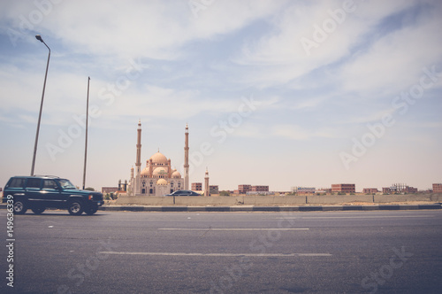 cairo, egypt, may 6, 2017: laylat al-qadr mosque at cairo ismaileya desert road with view of car