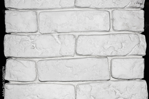 White narrow brick wall isolated on black.