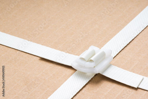 Billede på lærred close up of freight parcel with plastic fasten strap background
