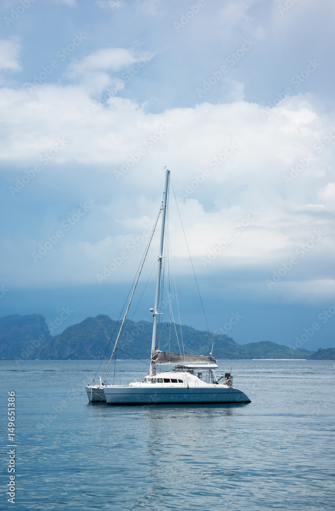 the luxury boat, yachts anchor near the coast against very cloudy