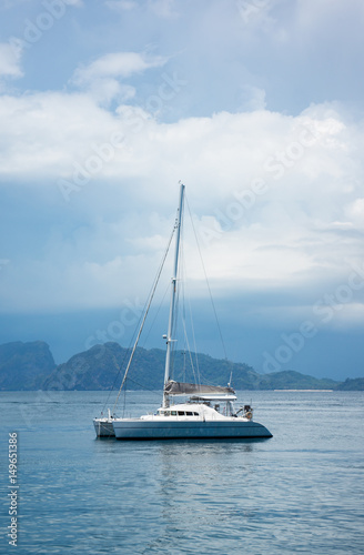 the luxury boat, yachts anchor near the coast against very cloudy