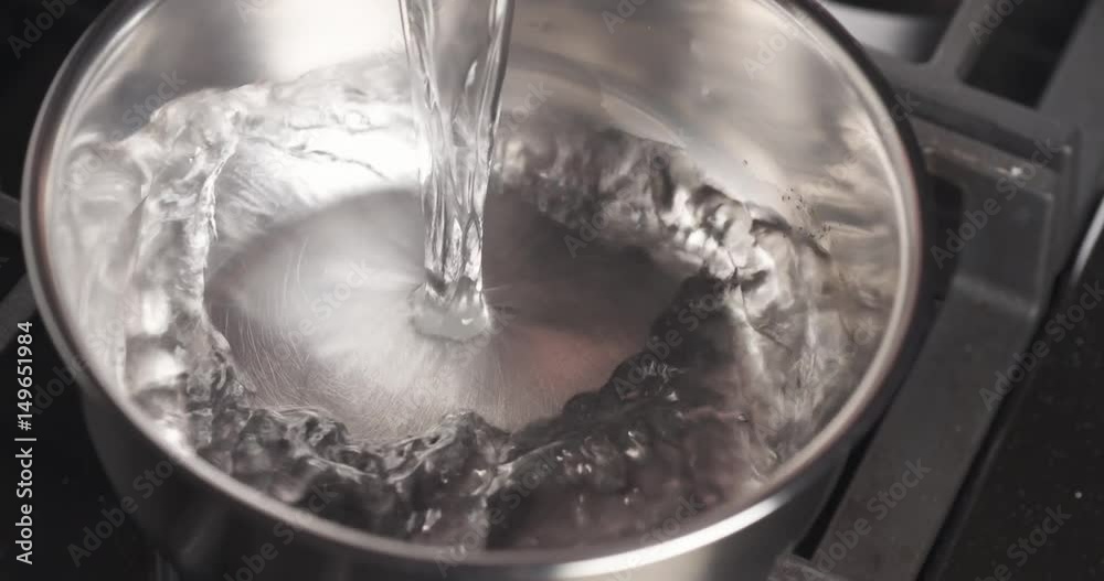 Handheld shot of pouring water into saucepan, 4k 60fps prores Handheld shot of pouring water into saucepan, 4k 60fps prores