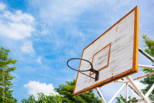 old basketball hoop at the park with space of blue sky