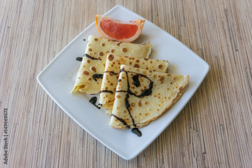 Dessert of pancakes on plate on table with eggs Dessert of pancakes on plate on table with eggs
