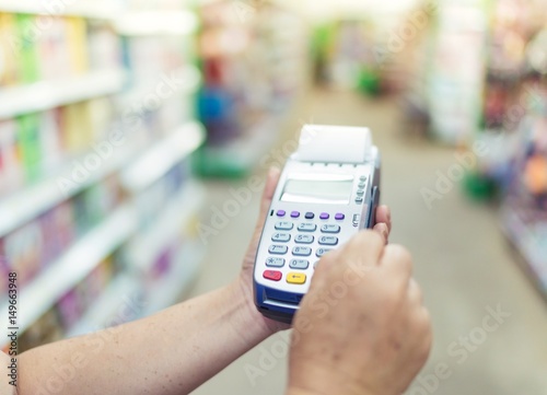 Payment using chip plastic card in POS terminal on hand holding. Credit card payment, buy and sell products & service. 