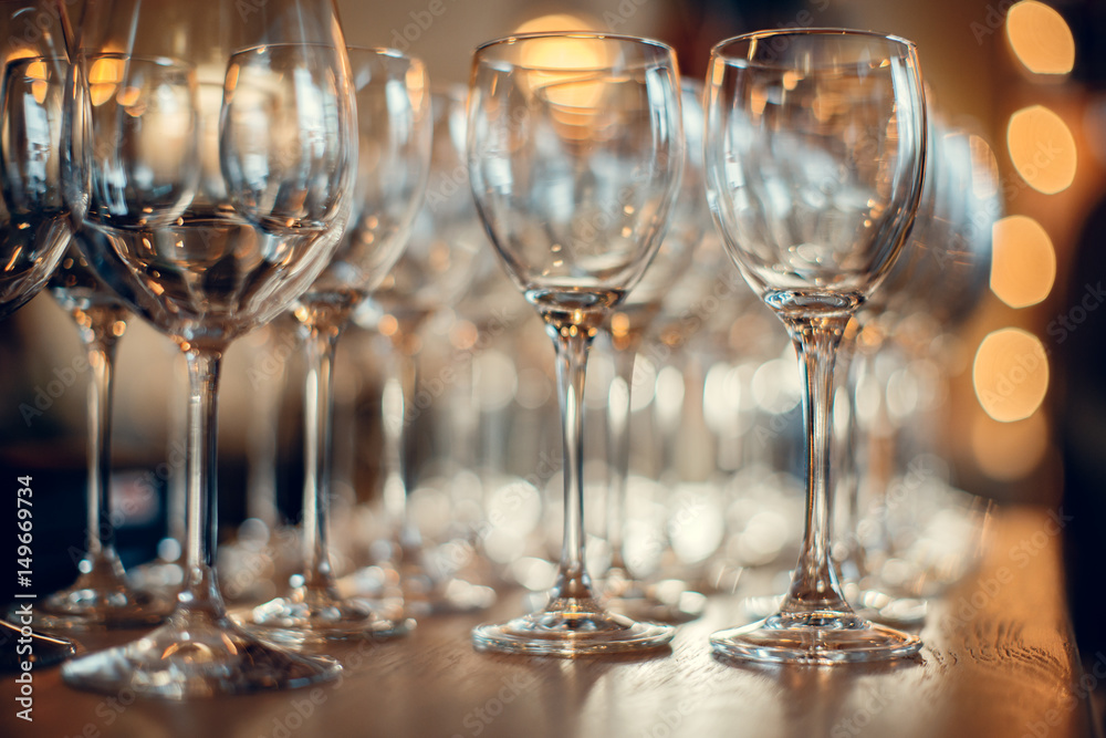 Close up picture of empty glasses on the wooden counter in restaurant Close up picture of empty glasses on the wooden counter in restaurant