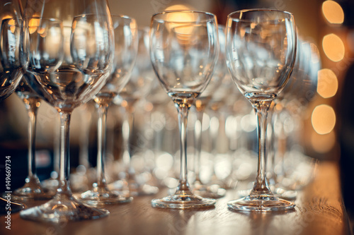 Close up picture of empty glasses on the wooden counter in restaurant