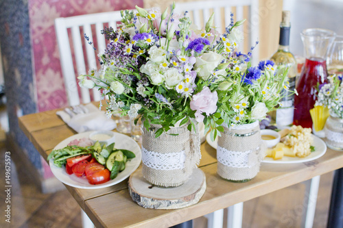 Wedding festive interior, table decorations, flowers, table setting, wine glass, pastel summer tones