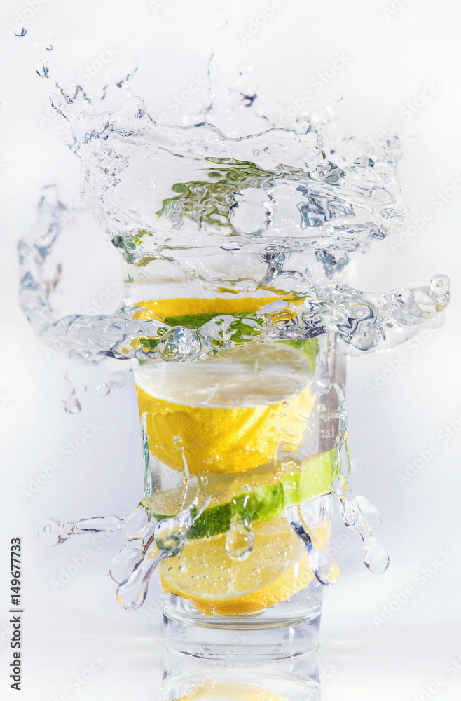 Lemons and limes in the glass. Concept and idea of drink Lemons and limes in the glass. Concept and idea of drink