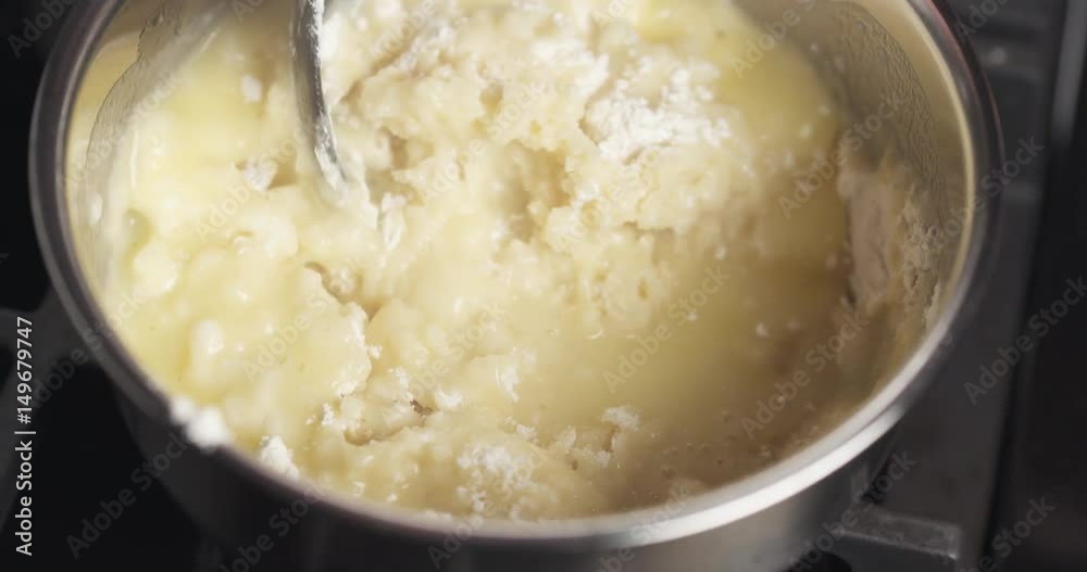 Handheld shot of mixing flour with butter mix for making choux dough, 4k 60fps prores footage Handheld shot of mixing flour with butter mix for making choux dough, 4k 60fps prores footage