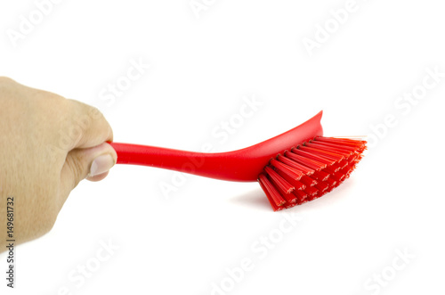 cropped image, hand holding red placstic brush isolated on white background photo