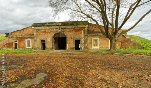 Leaves on the floor near the brick building © stonefy