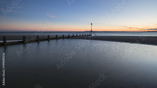 Beautiful vibrant Spring sunset long exposure beach landscape