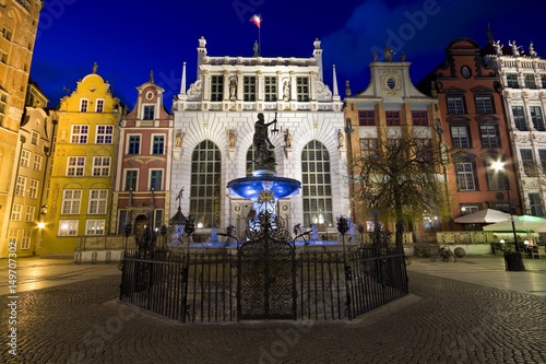Illuminated Neptune Fountain and Artus Court at Long Market (part of Royal Route) in Gdańsk at night, Poland