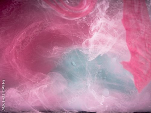 Abstract colored background. Colored smoke, ink in water, the patterns of the universe. Abstract movement, frozen multicolor flow of paint. Horizontal photo with soft focus, blurred backdrop.