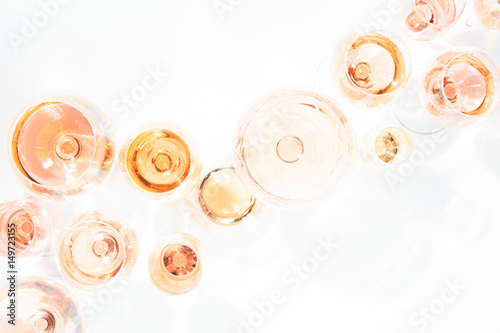 Many glasses of rose wine at wine tasting. Concept of rose wine and variety