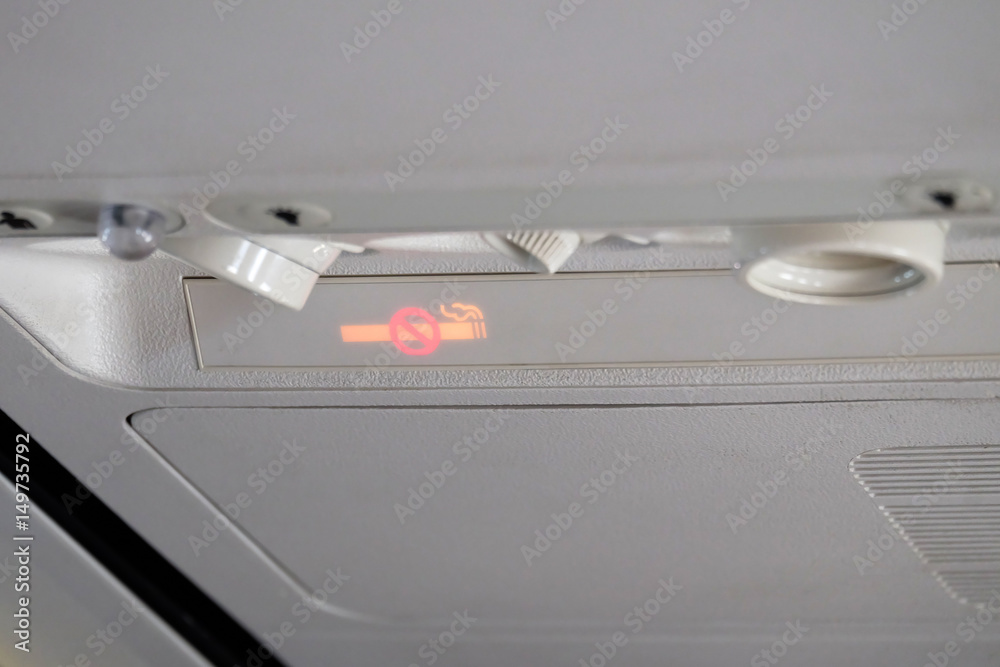 No smoking sign Mounted above the head in the aircraft cabin. No smoking sign Mounted above the head in the aircraft cabin.